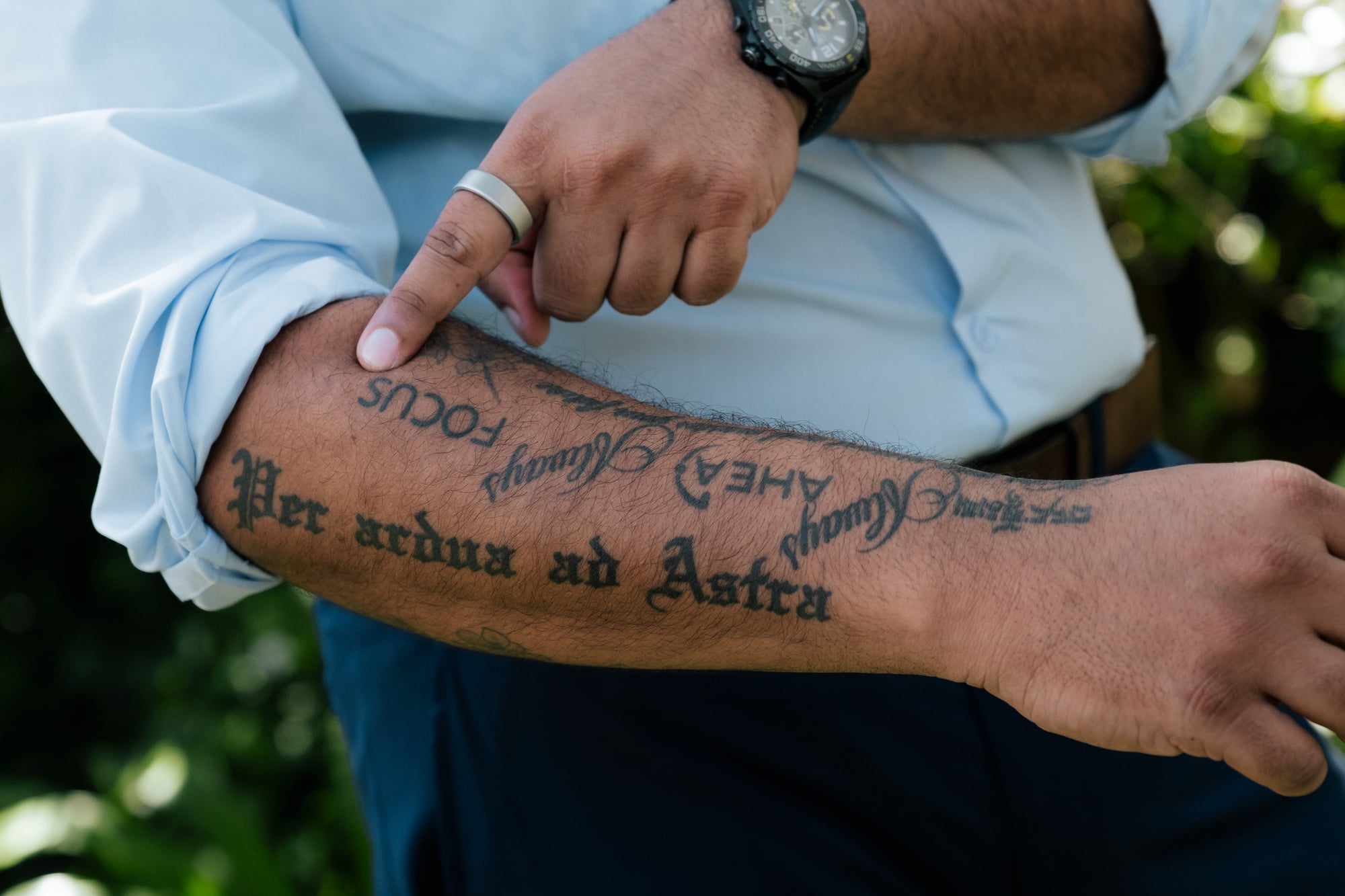 Forearm tattoo reading Per ardua ad Astra
